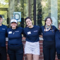 5 GVSU Alumni pose in front of dorm